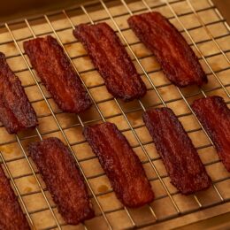Crispy bacon resting after baking to set texture.