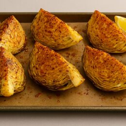 Finished baked cabbage boil – golden, garnished with lemon