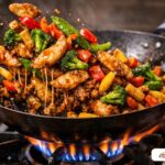 High-heat chicken stir-fry with a glossy sauce and vibrant vegetables.