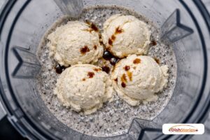 Large scoops of vanilla bean ice cream added to the blender jar for a thick cookies and cream shake.
