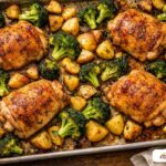 Golden roasted chicken and vegetables on a sheet pan, demonstrating the Maillard reaction.