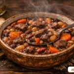 A deep bowl of thick, multi-colored bean soup with chunks of beef and carrots