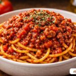 Savory spaghetti with meat sauce showing the emulsified sauce clinging to the pasta