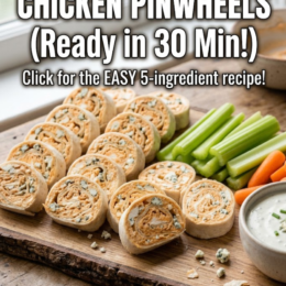 Buffalo chicken pinwheels served on a party platter with ranch dressing, celery sticks, and carrot sticks.
